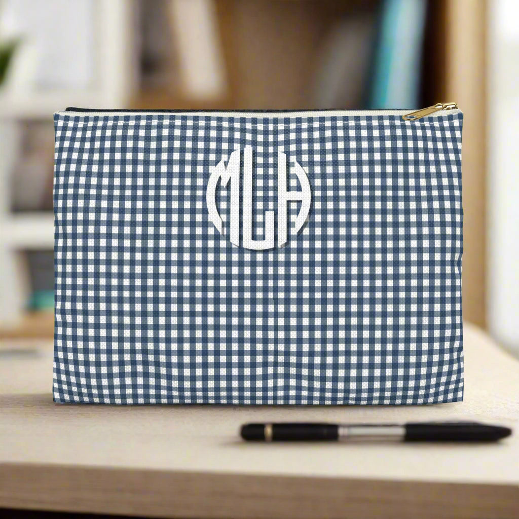 Blue and white checkered pouch with monogram on a white background