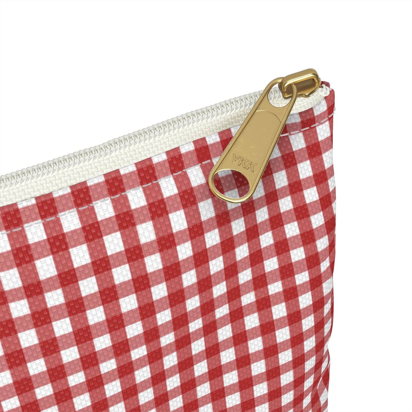 Red and white checkered pouch with a gold zipper pull on a white background