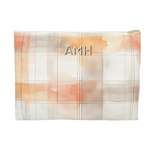 Plaid patterned pouch with 'AMH' initials on a white background