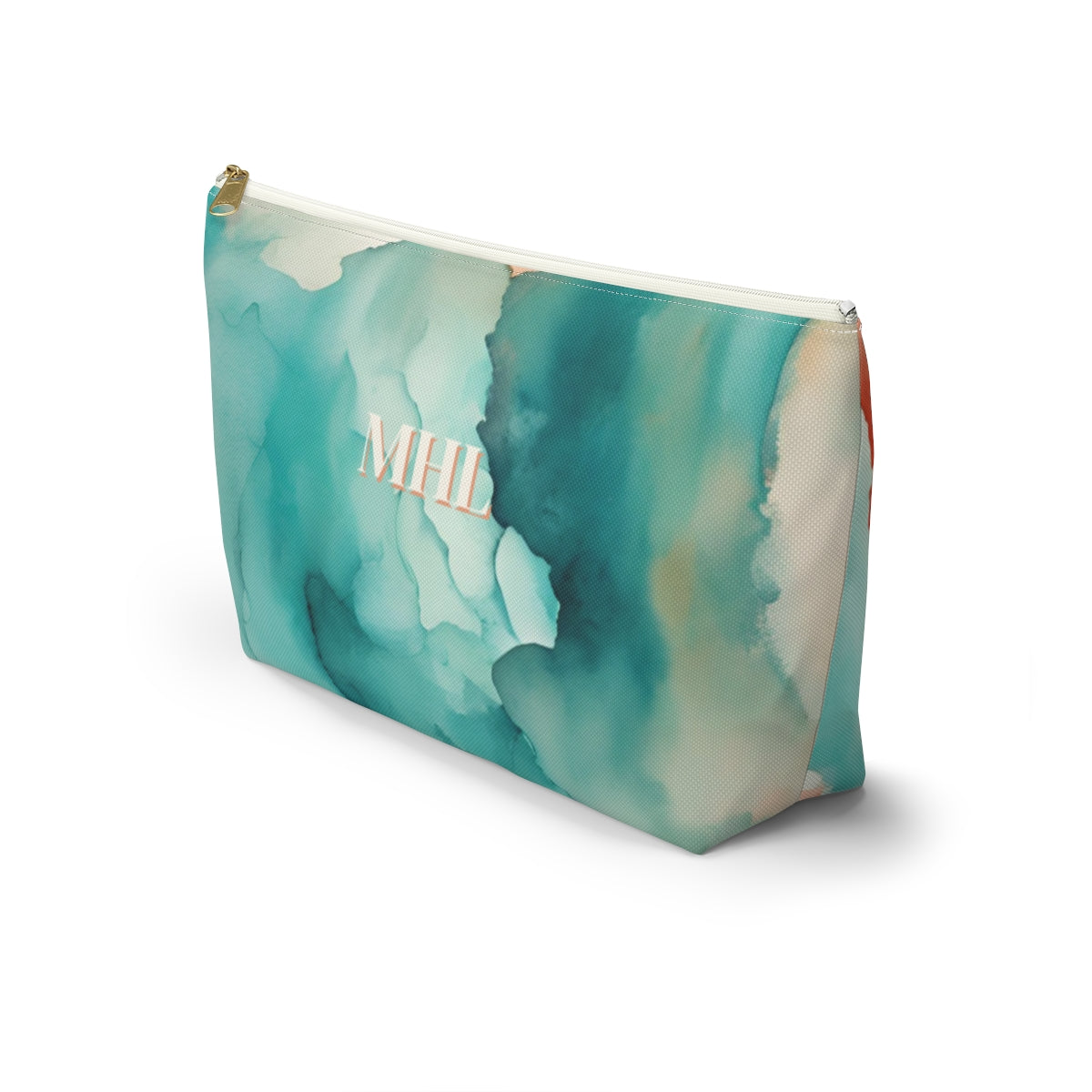 angled side view of Monogrammed cosmetic travel bag in a cream, turquoise, and orange abstract watercolor print