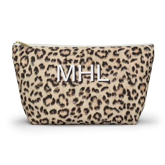 front view of personalized cosmetic travel bag with white monogram on cheetah print background