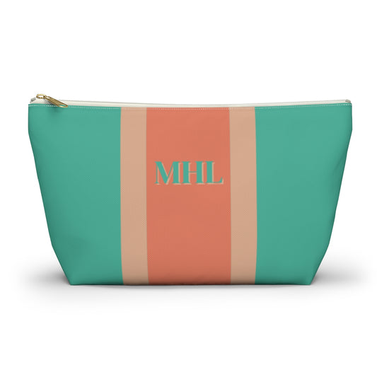 Monogrammed cosmetic travel bag with orange and turquoise stripes and white and gold zipper