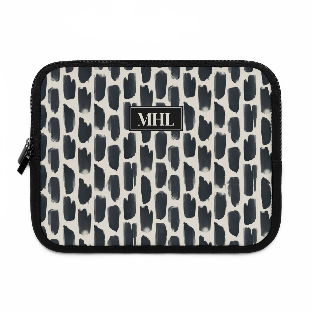 front view of personalized neoprene laptop sleeve with a cream colored monogram on  a repeating abstract pattern of animal spots in black