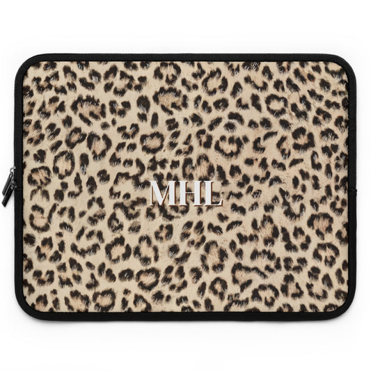 front view of personalized neoprene laptop sleeve with white monogram on leopard print background