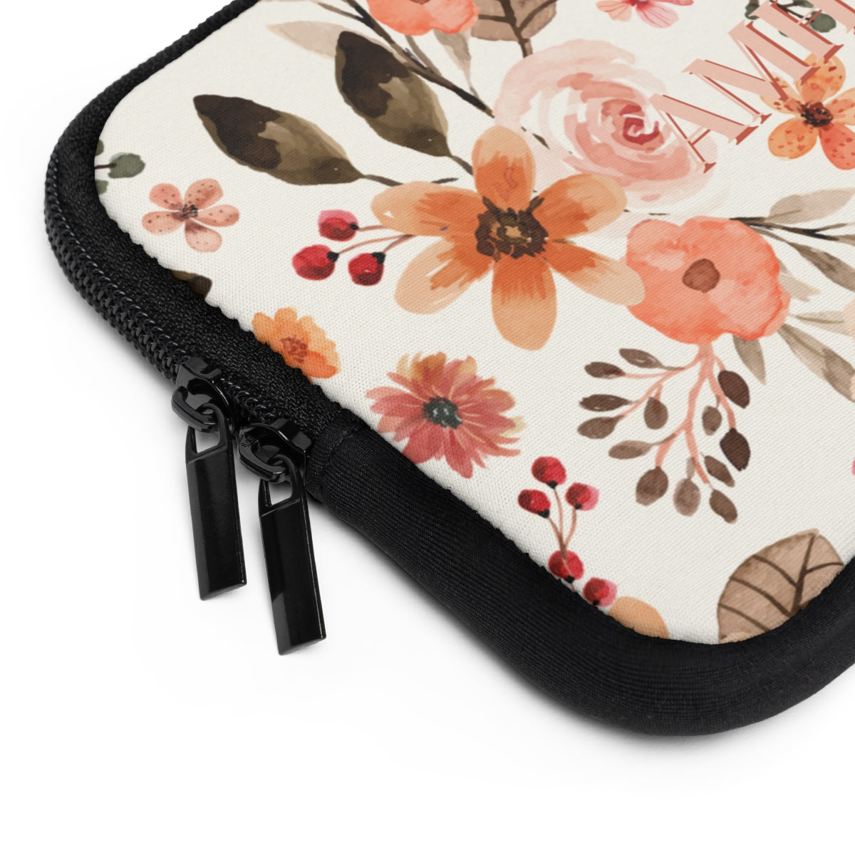 close up view of zipper of neoprene laptop sleeve  with vintage pink floral design 