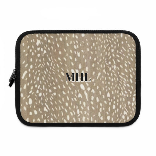 Front side of neoprene personalized laptop sleeve with black monogram on a spotted deer print pattern background in brown and cream