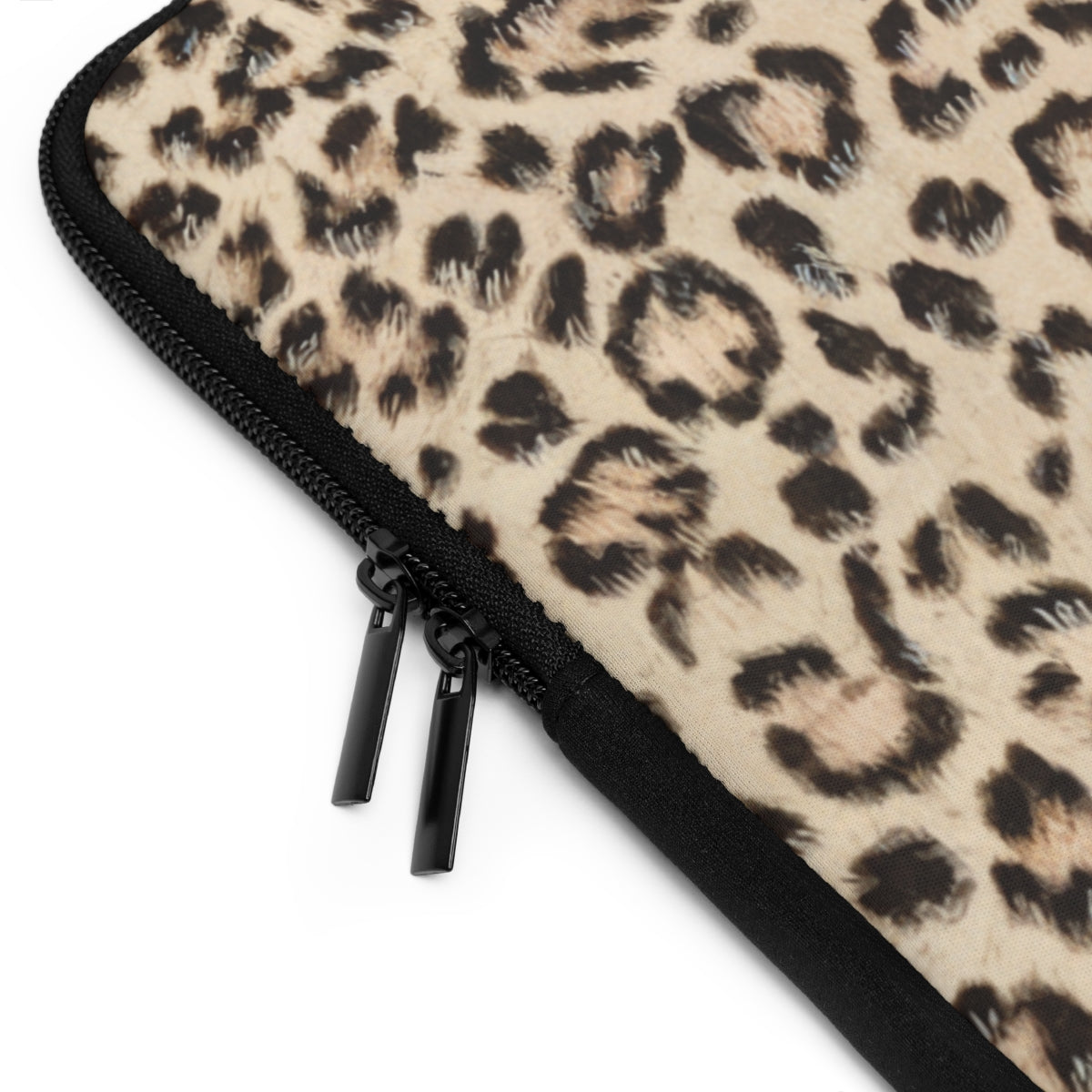 close up view of black zipper on personalized neoprene laptop sleeve with white monogram on leopard print background