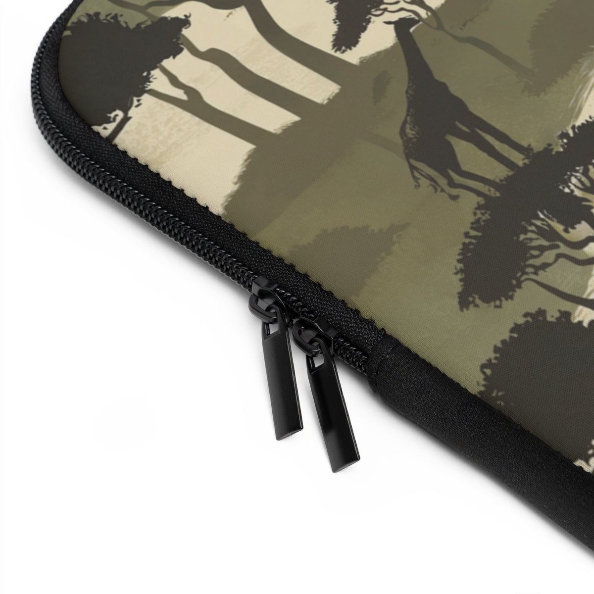 close up view of black zipper on monogrammed laptop case with repeating giraffe and tree pattern in olive green and cream