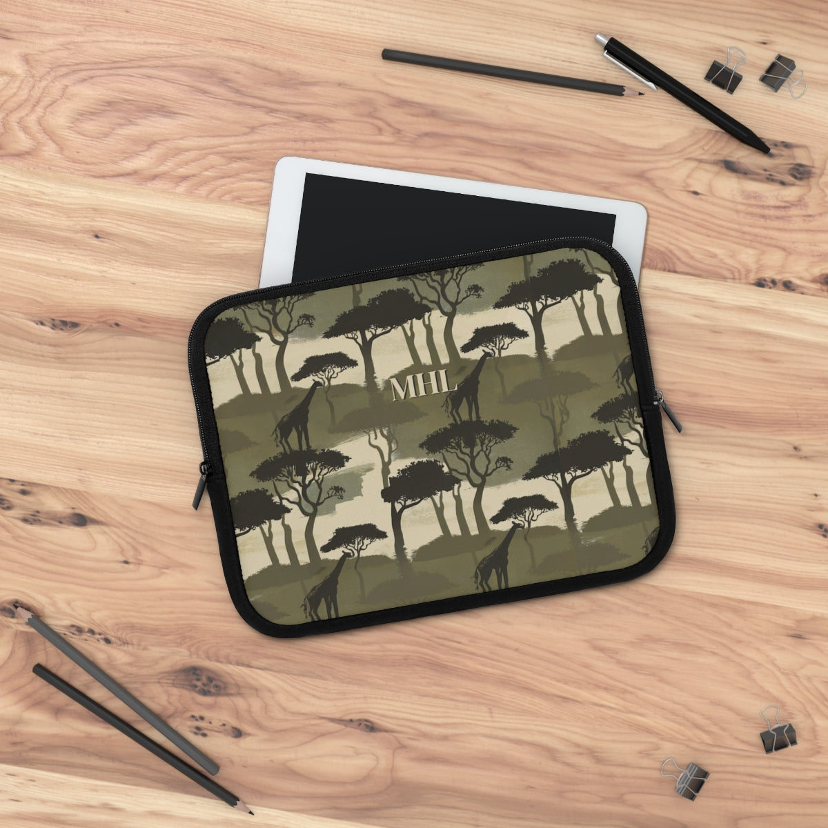 monogrammed laptop case with repeating giraffe and tree pattern in olive green and cream