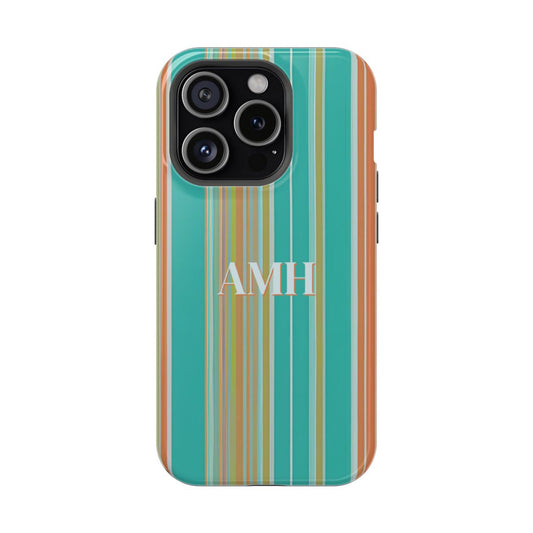 front view of personalized magnetic tough iPhone case with white monogram against a background of vertical stripes in turquoise, coral, and yellow