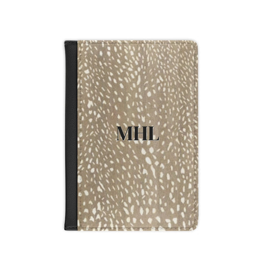 personalized passport cover with a black monogram on a cream and brown spotted deer print background 