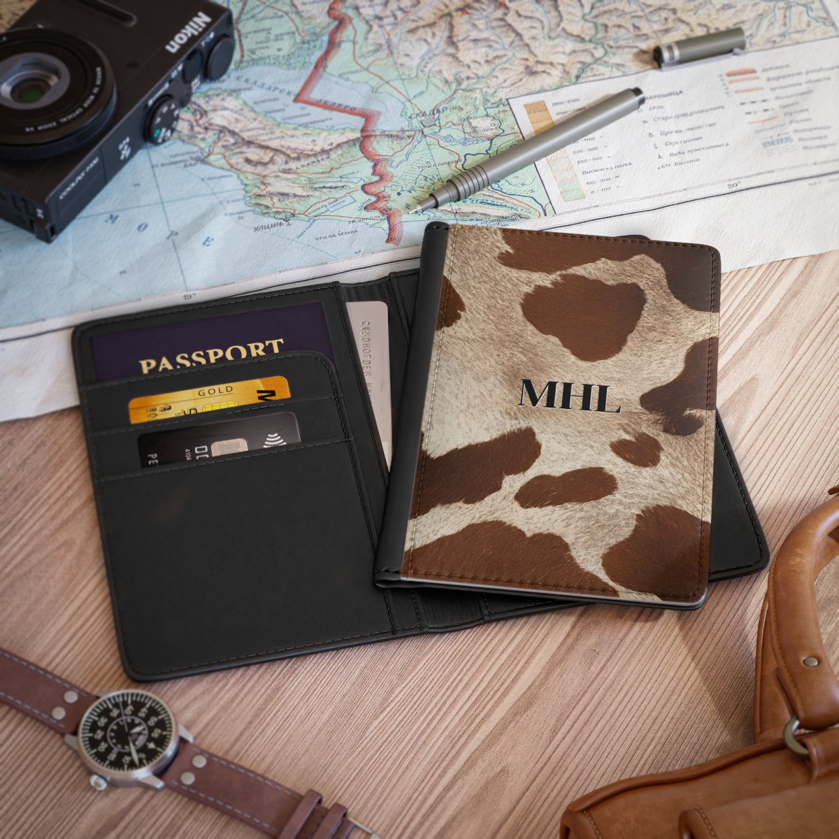 personalized passport cover with cowhide pattern in brown and cream on a table