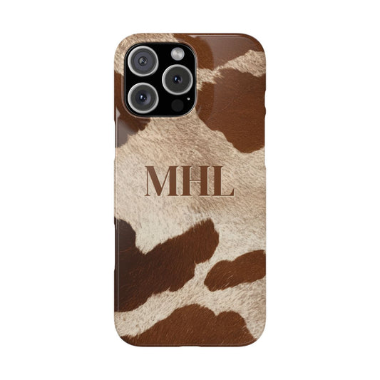 Front view of personalized slim iPhone case with brown monogram on brown and cream cowhide print background