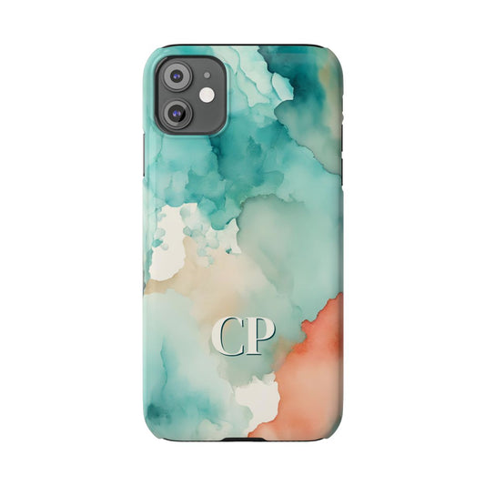 personalized slim iPhone case with cream monogram on an abstract watercolor background in turquoise, coral, and cream