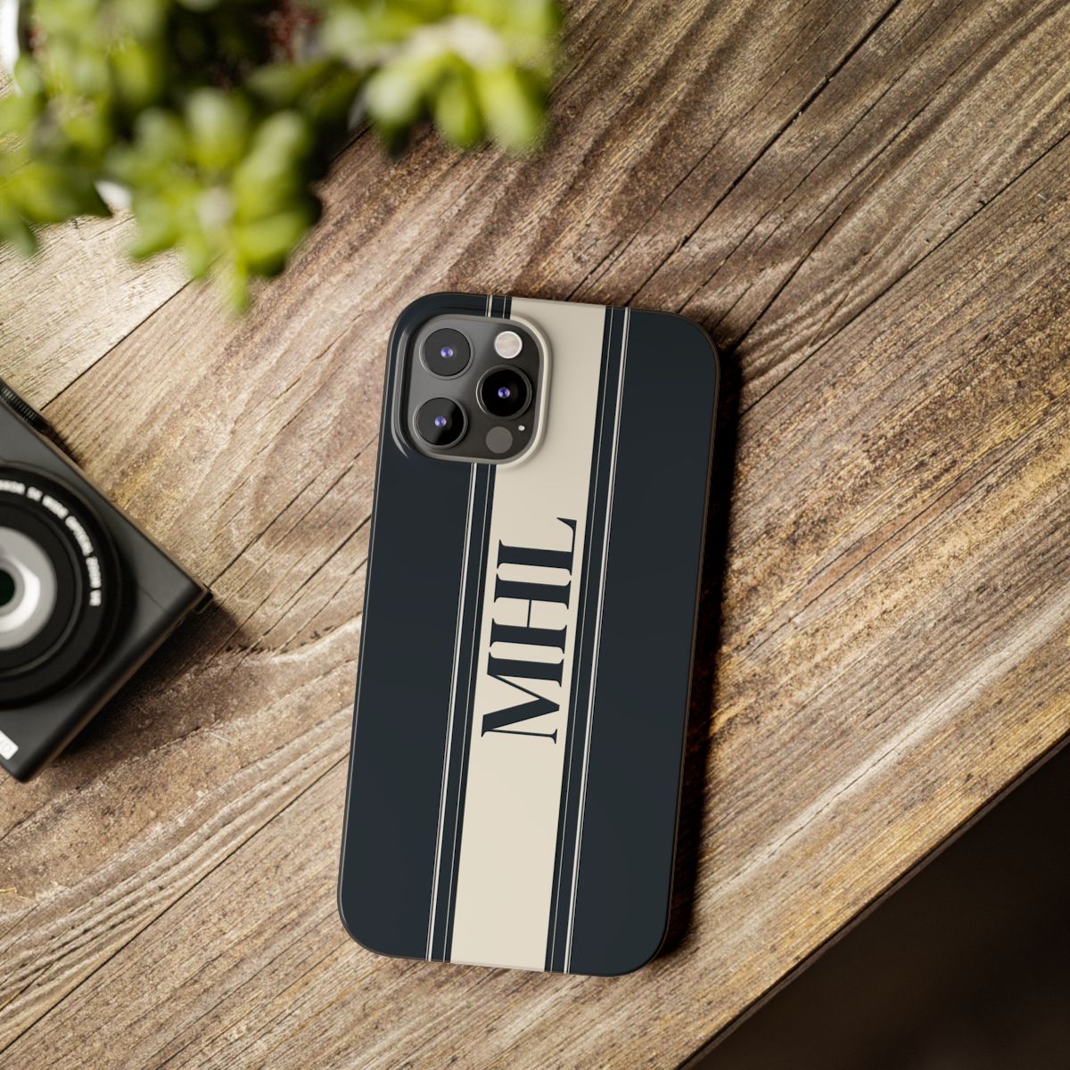 front view of personalized slim iPhone case with black monogram on a cream and black vertical striped background