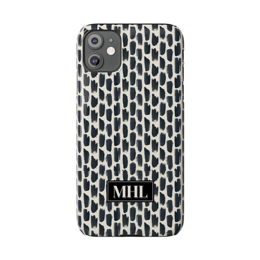 front view of personalized slim iPhone case with a cream colored monogram on  a repeating abstract pattern of animal spots in black